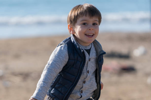 istock Little Boy running  at the beach 915567792