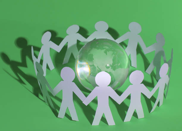 istock group of paper men standing around the glass globe 915570922
