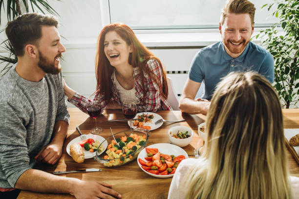 istock Cheerful friends communicating while enjoying in a meal at dining table. 915581812