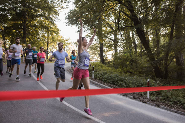 istock Successful marathon runner crossing the finish line in the forest. 915585402