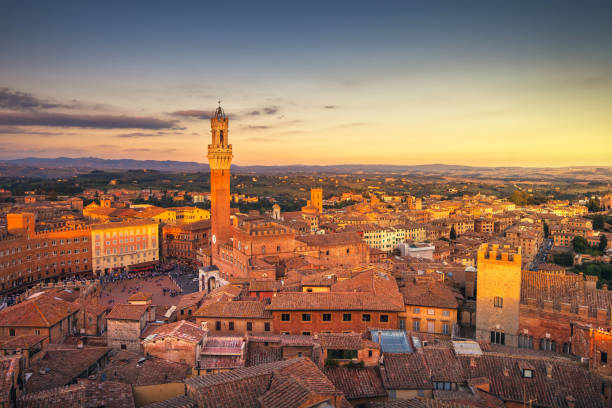 istock Siena sunset panoramic skyline. Mangia tower landmark. Tuscany, 915586342