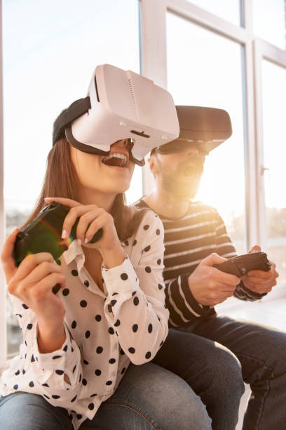 istock Startled beautiful woman starting VR game 915586402