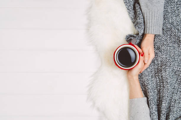 istock Couple holding hands with coffee on white table, top view 915590276
