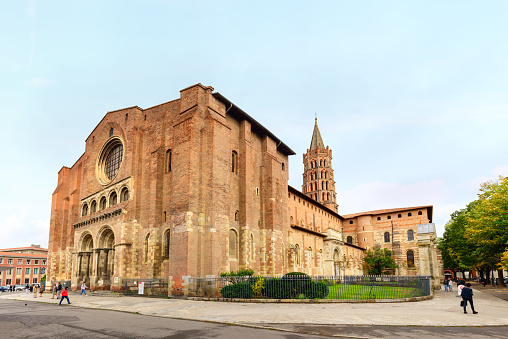 Toulouse, France - October 06, 2017:  Basilica of Saint-Sernin, Toulouse, France. The Basilica of Saint Sernin in Toulouse is the largest Romanesque church in Europe. The church constructed with local red brick and white stone in the 11th century. Nowadays the church is a UNESCO World Heritage Site.
