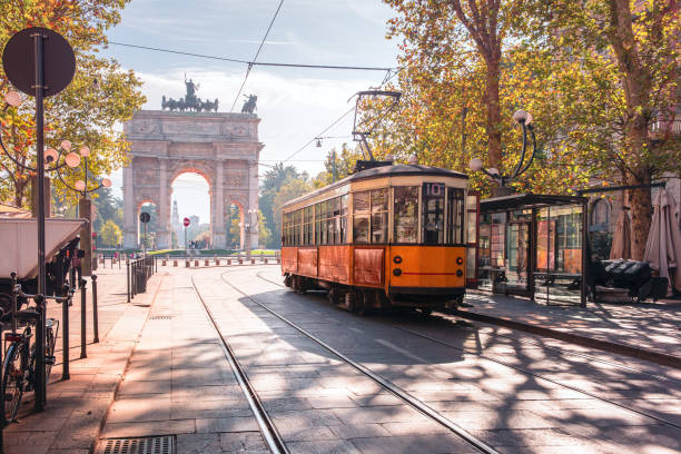 Famous vintage tram in Milan, Lombardia, Italy Famous vintage tram in the centre of the Old Town of Milan in the sunny day, Lombardia, Italy. Arch of Peace, or Arco della Pace on the background. cable car photos stock pictures, royalty-free photos & images