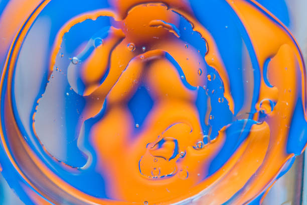 istock Oil on water - abstract macro background. 915605366