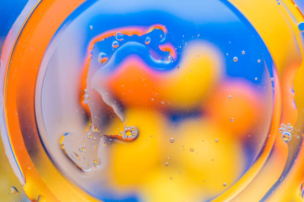 istock Oil on water - abstract macro background. 915605384