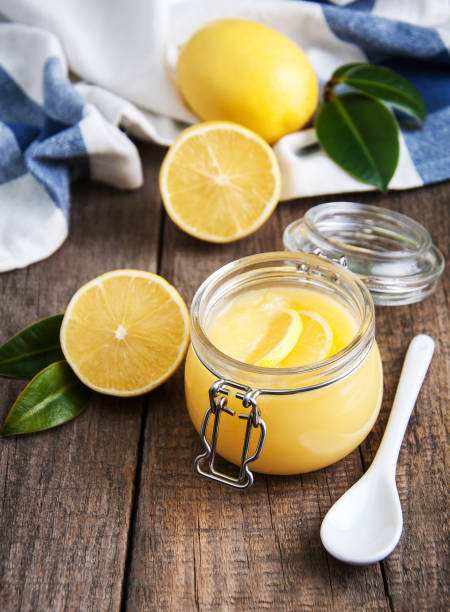 istock Lemon curd in glass jar with fresh lemons 915608914