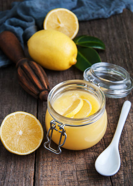 istock Lemon curd in glass jar with fresh lemons 915608962