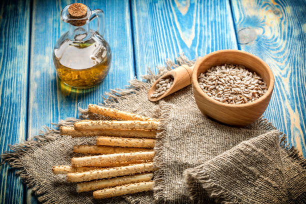 istock Fresh baked grissini bread on wooden board. 915611314