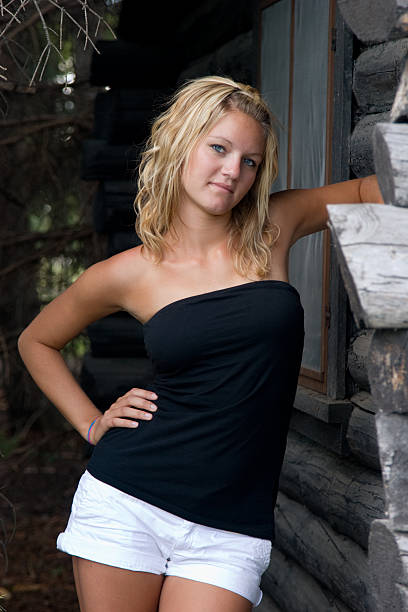 istock Beautiful young female at log cabin 91561178