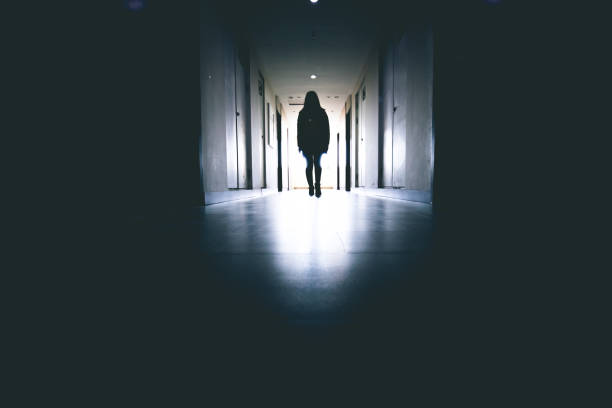 istock woman standing in a corridor 915612608