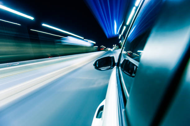 istock Driving a car at night trough tunnel 915612838