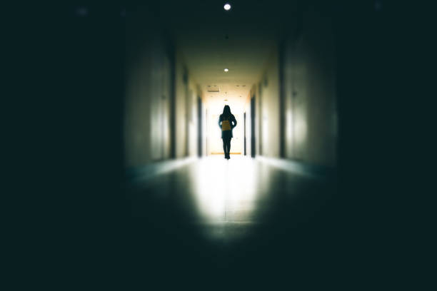 Young woman in dark building walkway