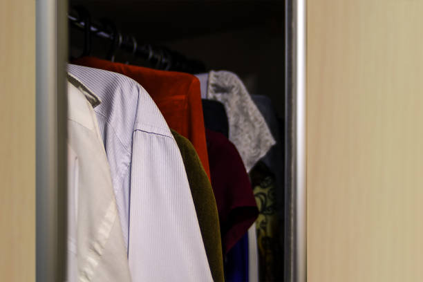 istock Wardrobe with clothes hanging on 915613072