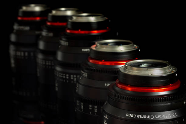 istock Professional Cinema Lens - camera lenses on the mirroring black background. 915613220