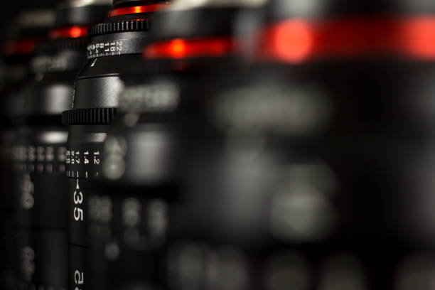 istock Professional Cinema Lens - camera lenses on the mirroring black background. 915613330