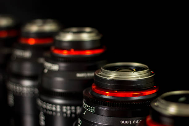 istock Professional Cinema Lens - camera lenses on the mirroring black background. 915613356