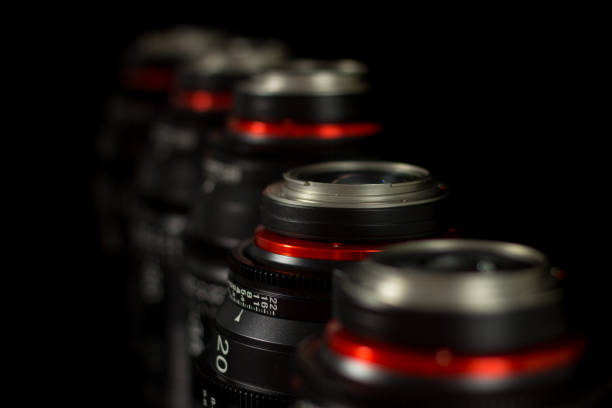 istock Professional Cinema Lens - camera lenses on the mirroring black background. 915613382