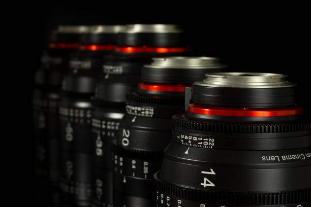 istock Professional Cinema Lens - camera lenses on the mirroring black background. 915613500