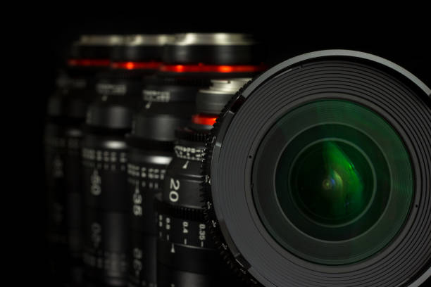 istock Professional Cinema Lens - camera lenses on the mirroring black background. 915613550