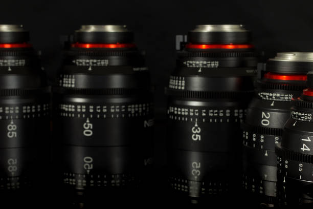 istock Professional Cinema Lens - camera lenses on the mirroring black background. 915613694