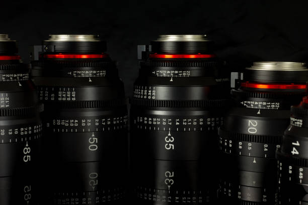 istock Professional Cinema Lens - camera lenses on the mirroring black background. 915613702