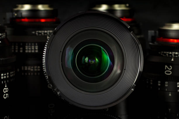 istock Professional Cinema Lens - camera lenses on the mirroring black background. 915613704