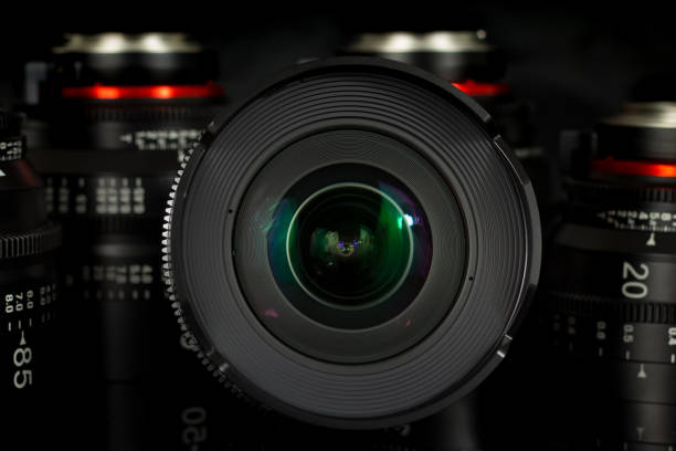 istock Professional Cinema Lens - camera lenses on the mirroring black background. 915613794