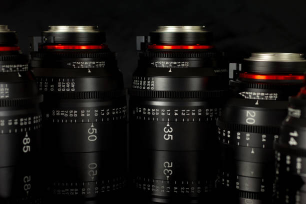 istock Professional Cinema Lens - camera lenses on the mirroring black background. 915613796