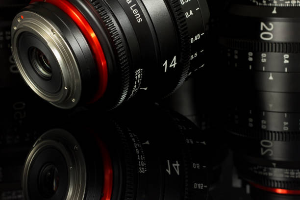 istock Professional Cinema Lens - camera lenses on the mirroring black background. 915614390