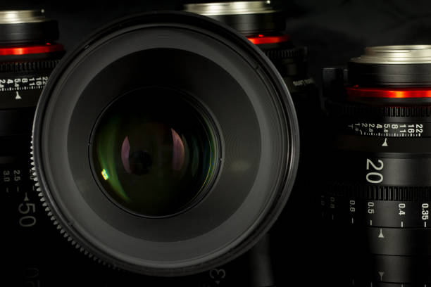 istock Professional Cinema Lens - camera lenses on the mirroring black background. 915616002