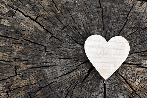 Heart for love on old wooden background.