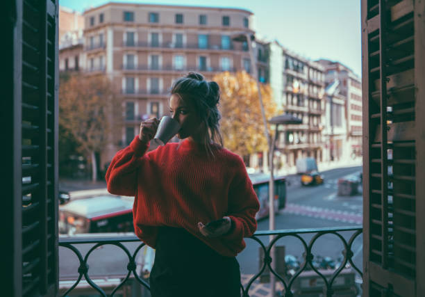 istock Girl drinking coffee at the balcony in Barcelona 915620794