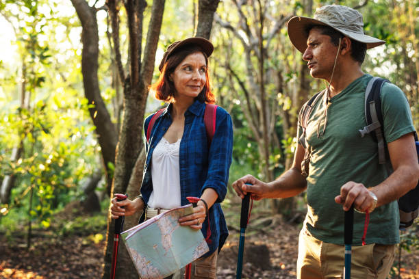 istock Couple trekking together in a forest 915623788