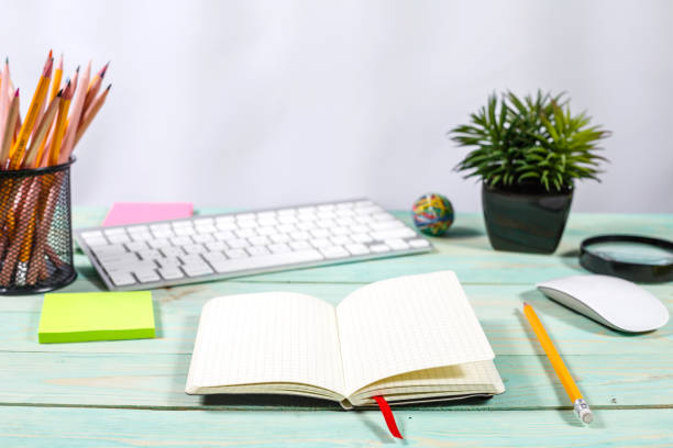 istock Office desk table with computer, supplies, flower and coffee cup 915624876