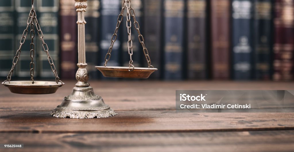 Scales of Justice and Law books on a  wooden background. Law and Justice, Legality concept, Scales of Justice l on a wooden background, Law library concept. Law Stock Photo