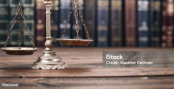 Scales Of Justice And Law Books On A Wooden Background Stock Photo - Download Image Now