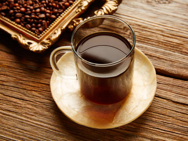 istock Coffee cup and beans on vintage golden tray 915625504