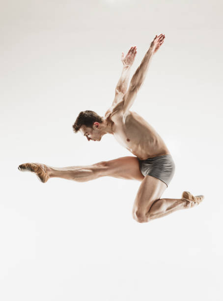 istock Athletic ballet dancer in a perfect shape performing over the grey background 915626926