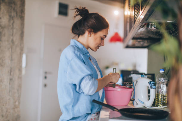 istock Young woman making pancakes 915629540