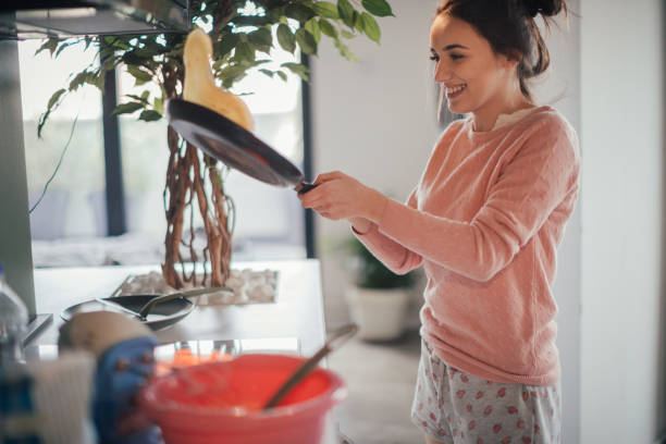 Young woman making pancakes