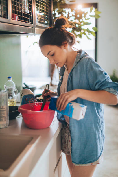 istock Young woman making pancakes 915629874