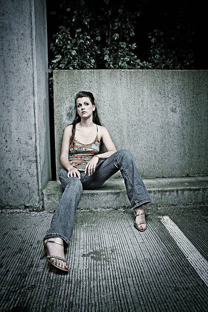 istock Young Woman Sitting on a Cement Curb 91563212