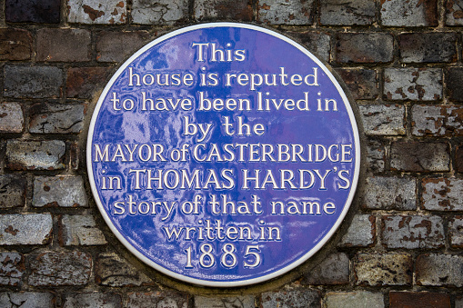 DORCHESTER, UK - AUGUST 15TH 2017: A blue plaque marking the location where the Mayor of Casterbridge reputed lived in the Thomas Hardy novel, taken on 15th August 2017.