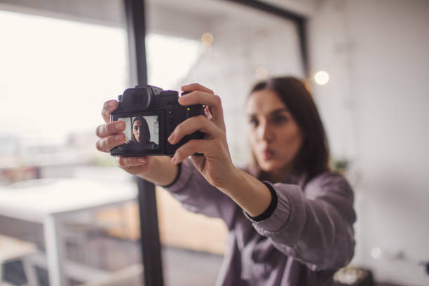 istock Young woman making selfie with a camera 915633456
