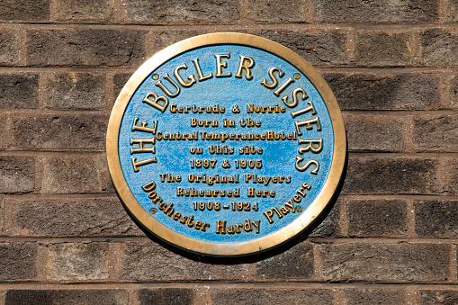 DORCHESTER, UK - AUGUST 15TH 2017: A blue plaque marking the location where Gertrude and Norrie Bugler rehearsed for plays adapted by Thomas Hardy, taken on 15th August 2017.