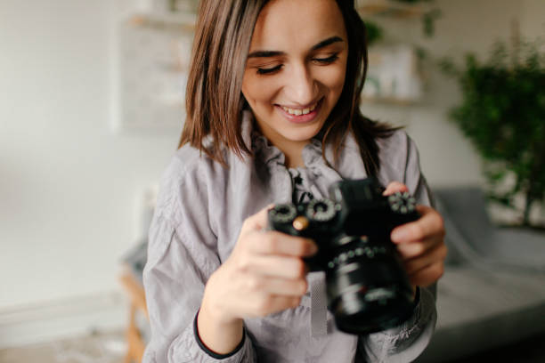 Young photographer checking photos on a camera