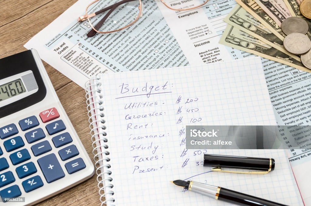 home budget with tax form, money and calculator Home Finances Stock Photo