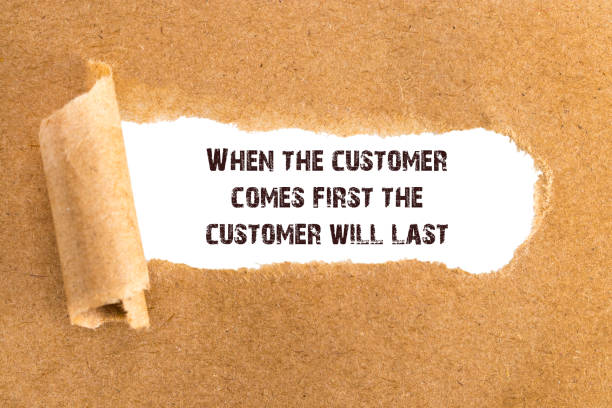 istock The text When the customer comes first the customer will last appearing behind torn brown paper 915636624
